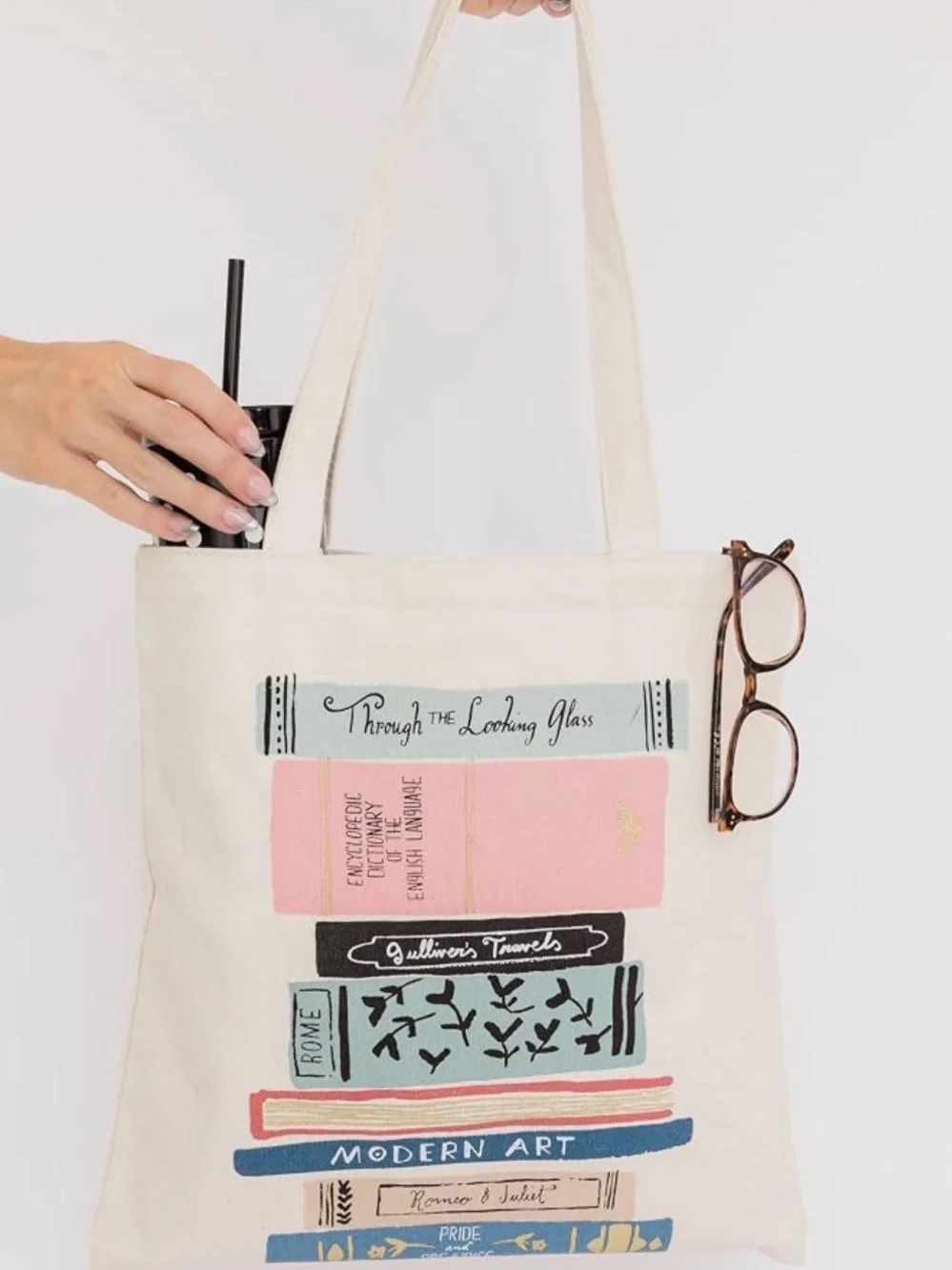 kate spade cream canvas tote with colorful book stack print